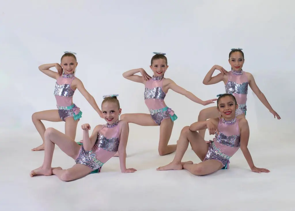 A group of young dancers posing in dance-wear.
