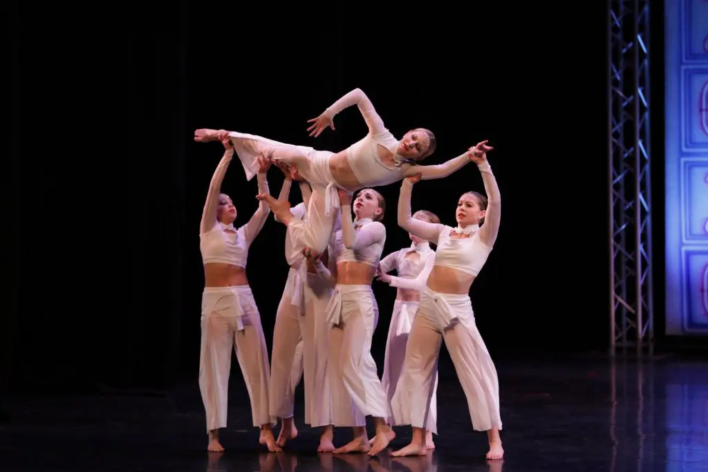 A group of dance students performing on-stage.