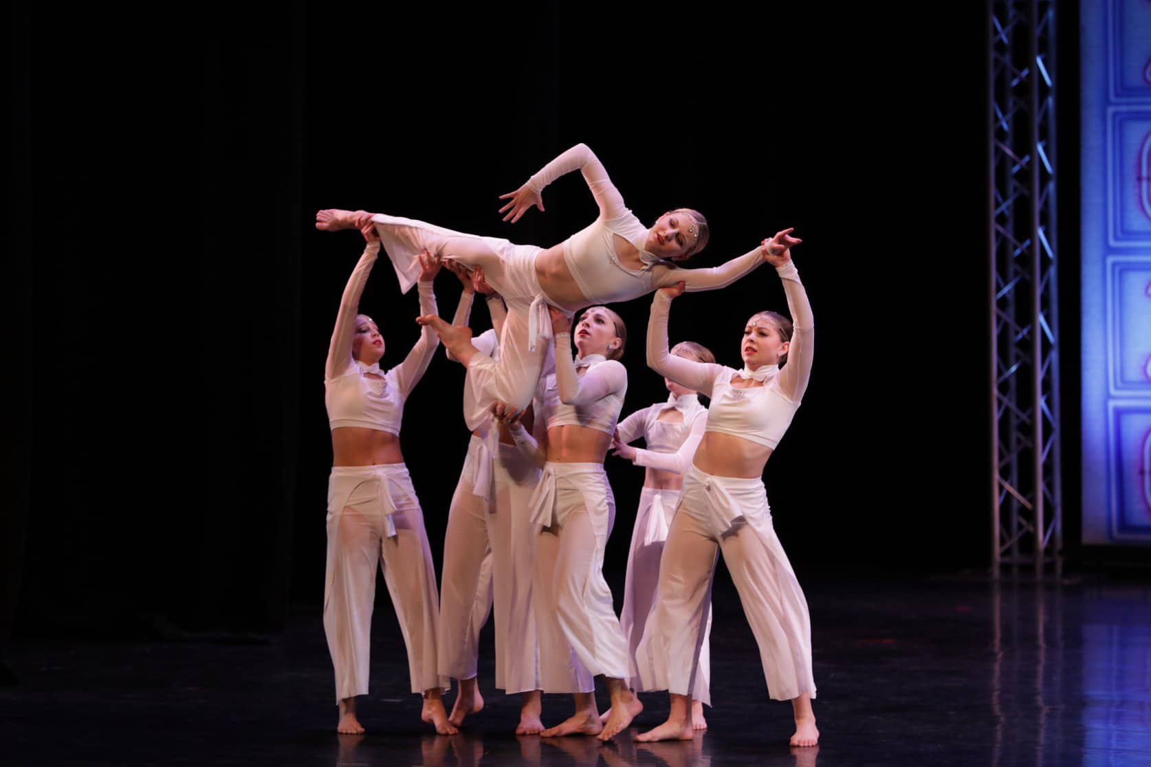A group of dance students performing on-stage.